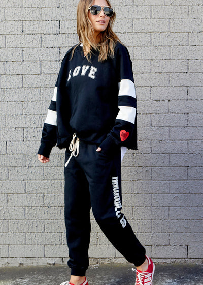 Hammill & Co Soft fleecy solid black track pant with feature Hammill and Co print down the left leg, elastic waist band with draw cord, 7/8 length and small Hammill and Co red heart logo on the right hip. 