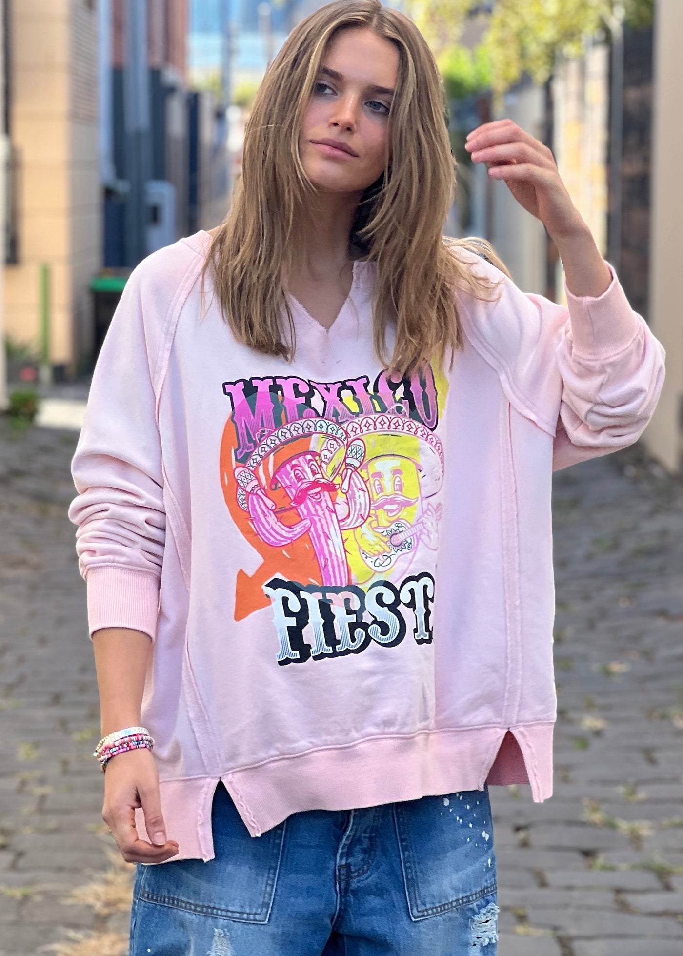 Hammill & Co oversized vintage wash sweat featuring raw cut v, exposed seams, wider rib waistband with side splits, raglan sleeve and new Mexican Fiesta print on the front and hand drawn logo on the back neck.
