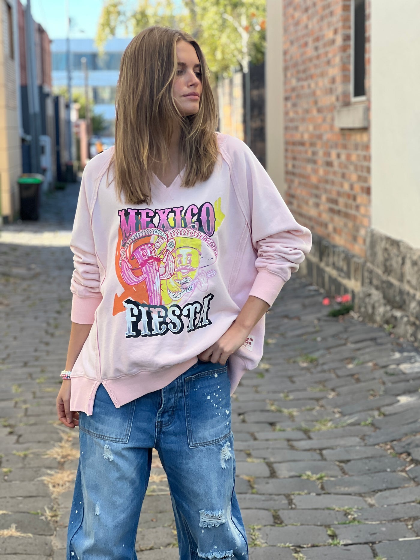 Hammill & Co oversized vintage wash sweat featuring raw cut v, exposed seams, wider rib waistband with side splits, raglan sleeve and new Mexican Fiesta print on the front and hand drawn logo on the back neck.
