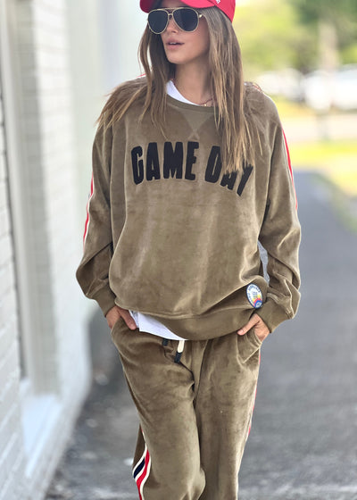 Hammill & Co slouchy sporty velour sweat in soft khaki with stripe tape down each sleeve and black Game Day chenille applique on the front. Looks great worn with the matching tracky pants or back with casual jeans