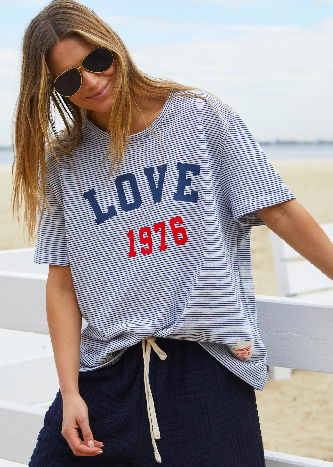 Hammill & Co tee is a total throwback in the best way. With fine navy and white stripes and a pop of red“1976 LOVE” across the front.