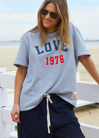 Hammill & Co tee is a total throwback in the best way. With fine navy and white stripes and a pop of red“1976 LOVE” across the front.