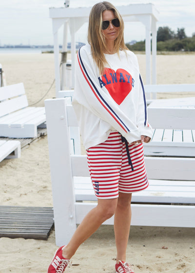 Hammill & Co Spring white sweat with bold navy and red print on the front and stripe tape down each sleeve. Rib hem, raglan sleeve and crew neck style. Our standard oversized boyfriend fit. Looks great worn back with the red/white stripe shorts.