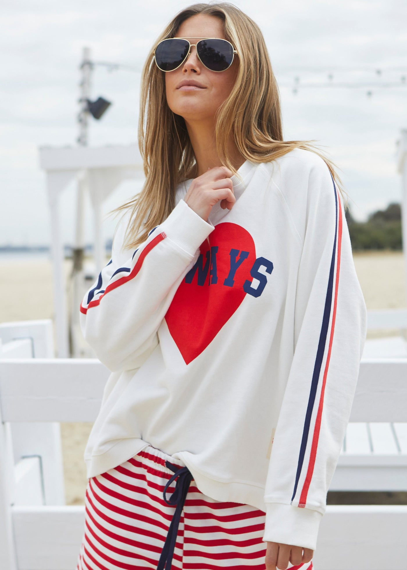 Hammill & Co Spring white sweat with bold navy and red print on the front and stripe tape down each sleeve. Rib hem, raglan sleeve and crew neck style. Our standard oversized boyfriend fit. Looks great worn back with the red/white stripe shorts.