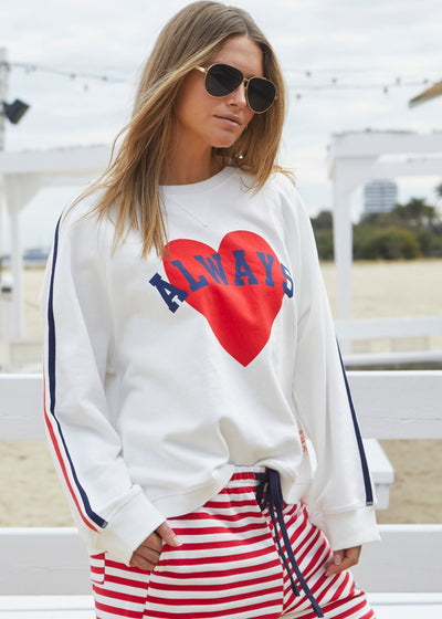 Hammill & Co Spring white sweat with bold navy and red print on the front and stripe tape down each sleeve. Rib hem, raglan sleeve and crew neck style. Our standard oversized boyfriend fit. Looks great worn back with the red/white stripe shorts.