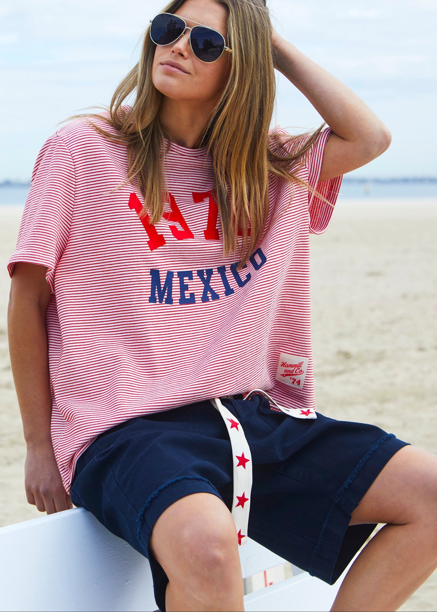 Hammill & Co tee is a total throwback in the best way. With fine red and white stripes and a pop of red and navy “1976 MEXICO” across the front.