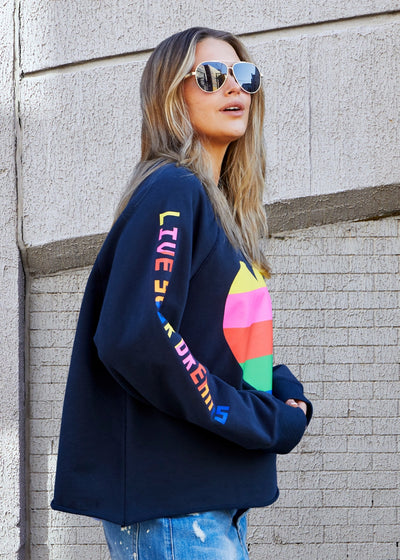 Hammill & Co Dark navy with multi coloured heart print on the front and multi coloured FOLLOW YOUR DREAMS down the right sleeve.