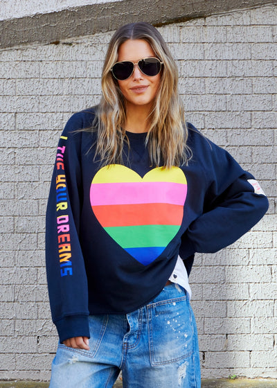 Hammill & Co Dark navy with multi coloured heart print on the front and multi coloured FOLLOW YOUR DREAMS down the right sleeve.