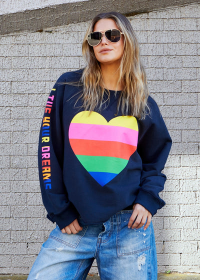 Hammill & Co Dark navy with multi coloured heart print on the front and multi coloured FOLLOW YOUR DREAMS down the right sleeve.