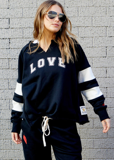 Hammill & Co Retro Love signature sweat in black with natural panelled sleeve detail, relaxed fit with raw V neckline, defined seaming, wide raw edge hem and a more boxy, wider fit! Chenille Love applique on the front.