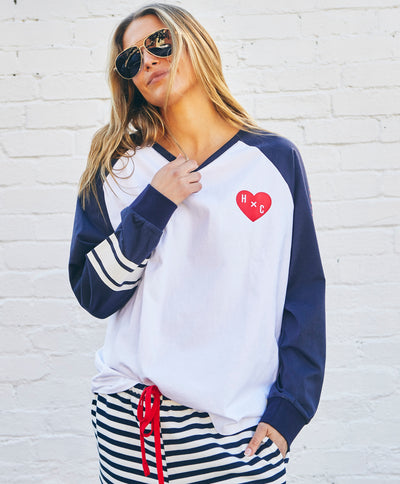 Hammill & Co Retro white long sleeve tee with contrast navy sleeves with pops of red print.