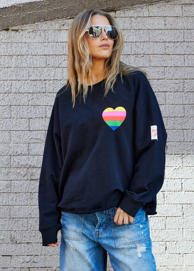 Hammill & Co Black sweat with small multi coloured heart print on the left chest and multi coloured FOLLOW YOUR DREAMS down the right sleeve
