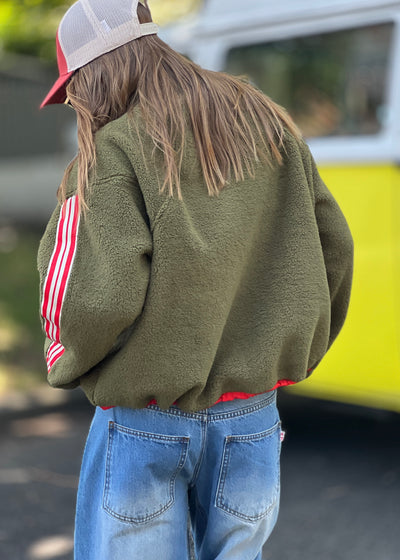 Hammill & Co Soft and cozy Khaki 1/2 zip polar fleece sweat. Featuring stripe tape down each sleeve, contrast placket and front zipper, slouchy pockets with red zips, adjustable waistband with elastic and toggle and higher neck style for extra warmth.
