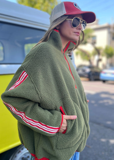 Hammill & Co Soft and cozy Khaki 1/2 zip polar fleece sweat. Featuring stripe tape down each sleeve, contrast placket and front zipper, slouchy pockets with red zips, adjustable waistband with elastic and toggle and higher neck style for extra warmth.