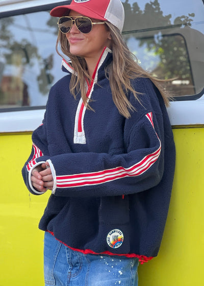 Hammill & Co Soft and cozy Navy 1/2 zip polar fleece sweat. Featuring stripe tape down each sleeve, contrast placket and front zipper, slouchy pockets with red zips, adjustable waistband with elastic and toggle and higher neck style for extra warmth.