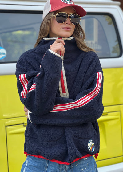 Hammill & Co Soft and cozy Navy 1/2 zip polar fleece sweat. Featuring stripe tape down each sleeve, contrast placket and front zipper, slouchy pockets with red zips, adjustable waistband with elastic and toggle and higher neck style for extra warmth.