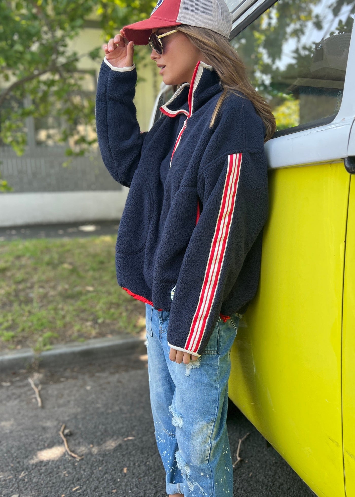 Hammill & Co Soft and cozy Navy 1/2 zip polar fleece sweat. Featuring stripe tape down each sleeve, contrast placket and front zipper, slouchy pockets with red zips, adjustable waistband with elastic and toggle and higher neck style for extra warmth.