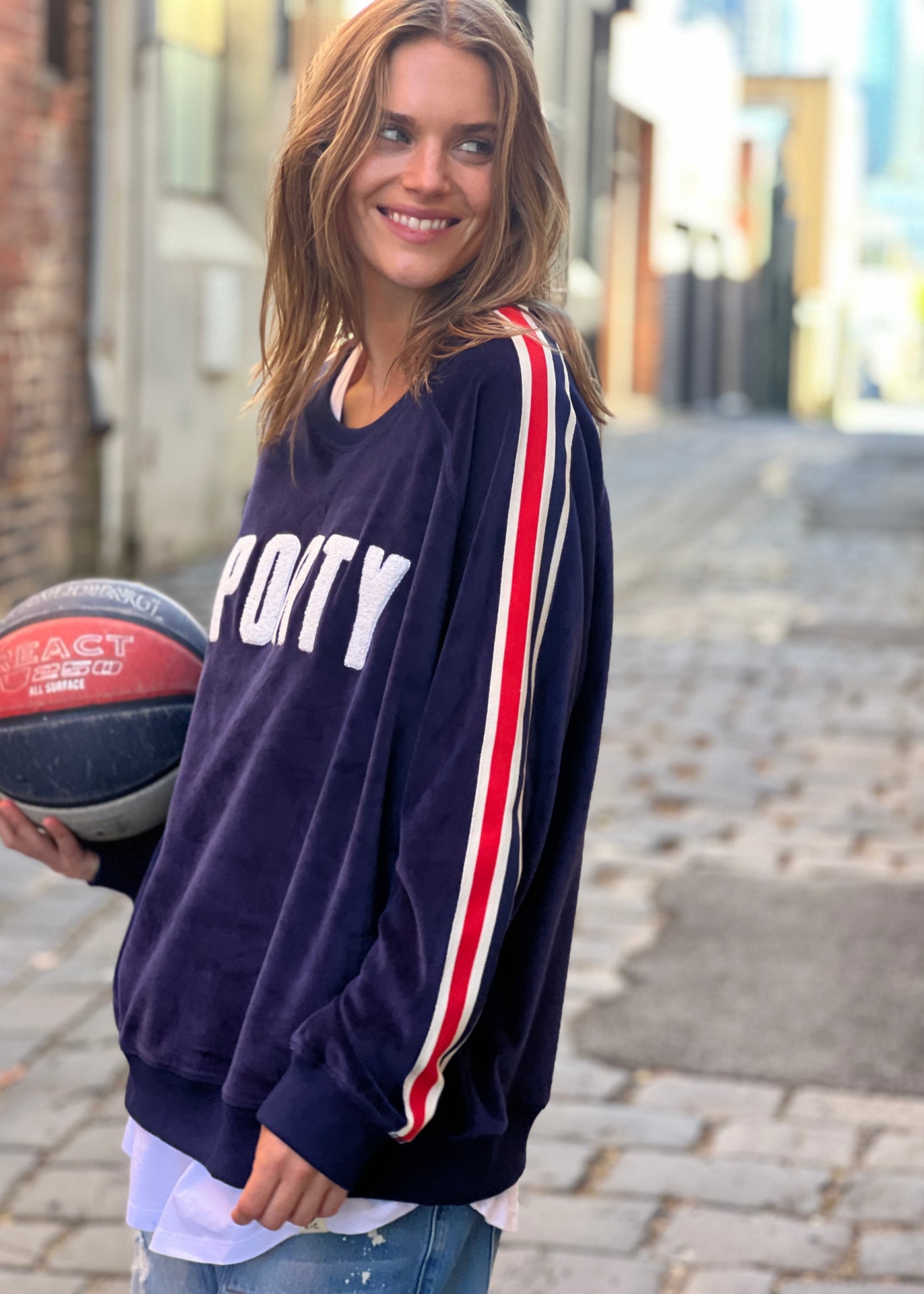 Hammill & Co  slouchy sporty velour sweat in navy with stripe tape down each sleeve and Sporty chenille applique on the front. Looks great worn with the matching tracky pants or back with casual jeans! 