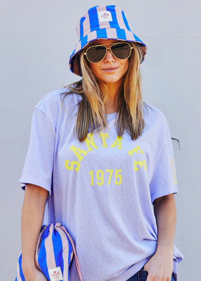 Hammill & Co bold striped bucket hat is pure summer happiness. Made from soft terry towelling in vibrant Royal and musk stripes.