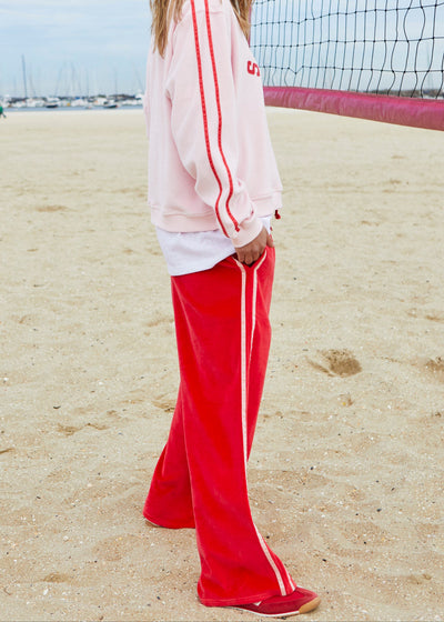 Hammill & Co New wider leg track pant in our luxurious, lightweight velour with velour stripes down each leg, draw cord and Hammill and Co logo print on left hem. The fit is a true to size, not oversized.