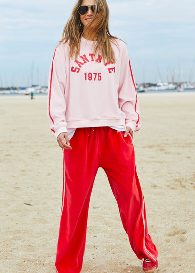Hammill & Co New wider leg track pant in our luxurious, lightweight velour with velour stripes down each leg, draw cord and Hammill and Co logo print on left hem. The fit is a true to size, not oversized.