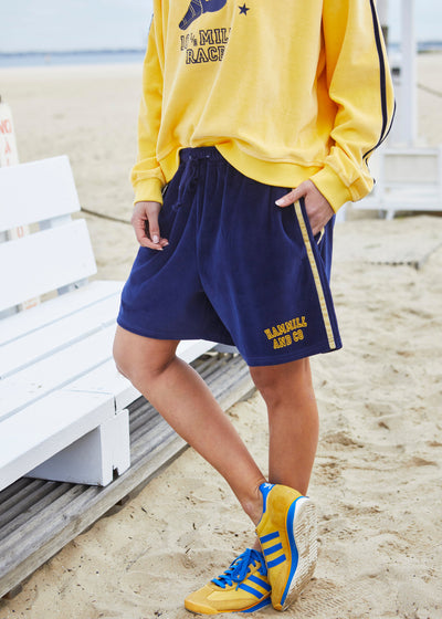Hammill & Co These shorts are in our luxurious, lightweight velour with velour stripes down each leg, draw cord and Hammill and Co logo print on the left hem. The fit is a true to size, not oversized.