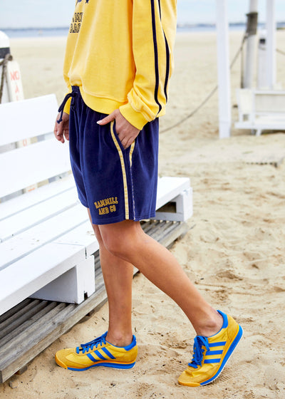 Hammill & Co These shorts are in our luxurious, lightweight velour with velour stripes down each leg, draw cord and Hammill and Co logo print on the left hem. The fit is a true to size, not oversized.