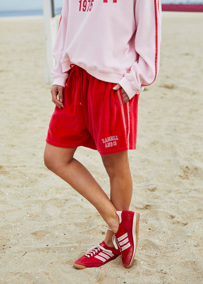 Hammill & Co These shorts are in our luxurious, lightweight velour with velour stripes down each leg, draw cord and Hammill and Co logo print on the left hem. The fit is a true to size, not oversized.