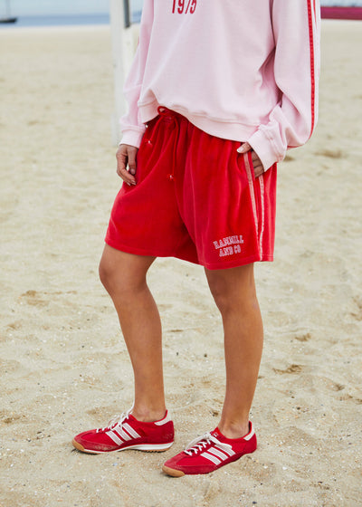 Hammill & Co These shorts are in our luxurious, lightweight velour with velour stripes down each leg, draw cord and Hammill and Co logo print on the left hem. The fit is a true to size, not oversized.