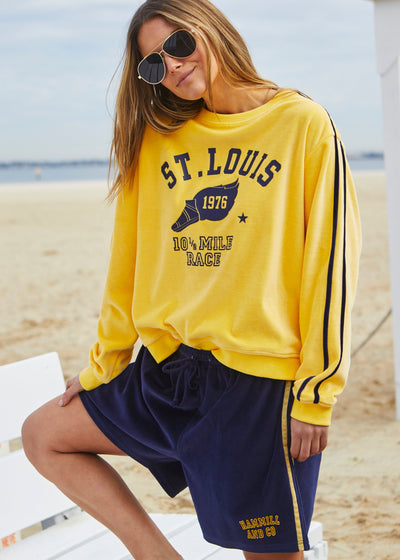 Hammill & Co Our standard fitting sweat with rib neck and waistband. Navy St. Louis retro print on the front and double navy velour tape down each sleeve.