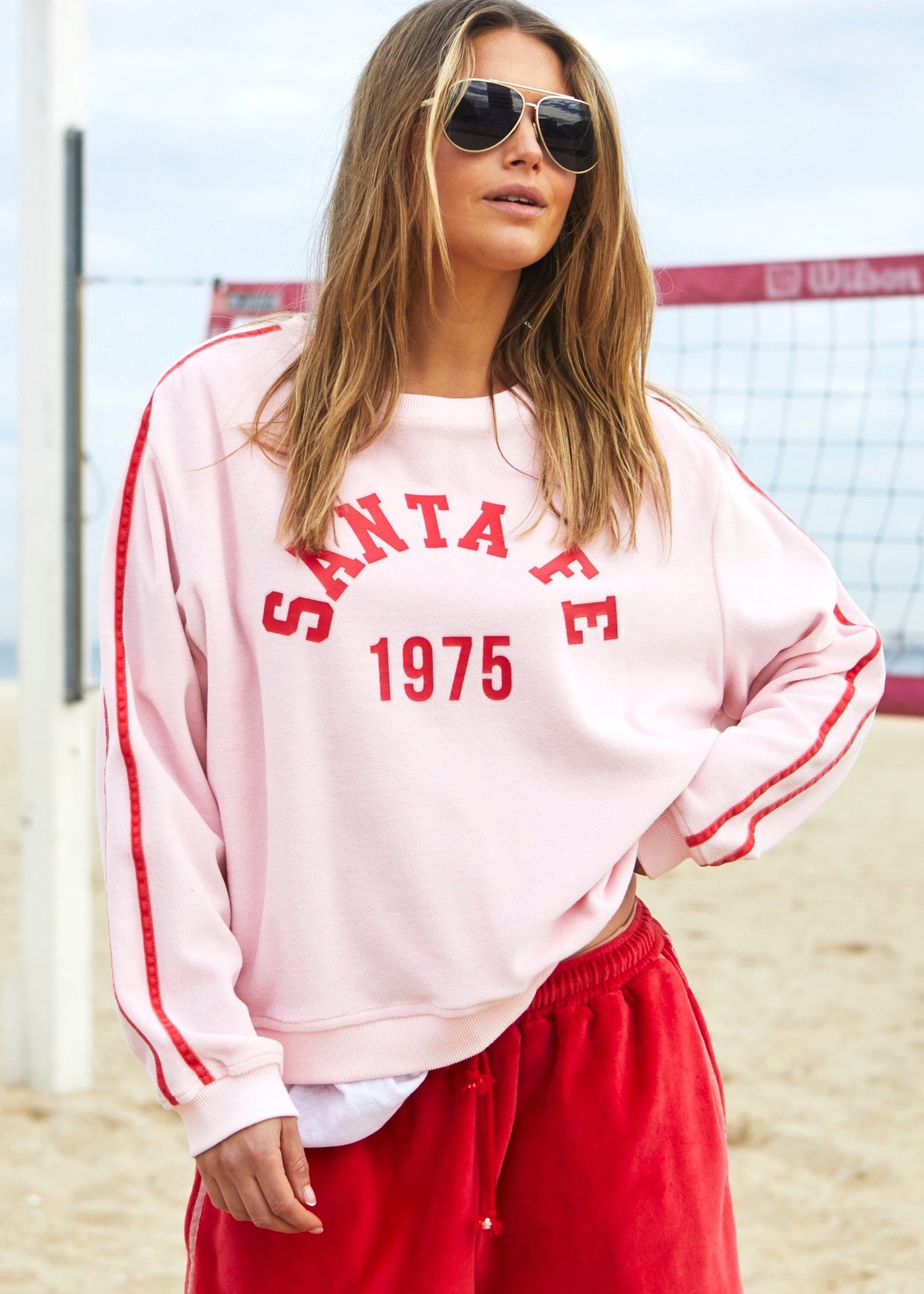 Hammill & Co Our standard fitting sweat with rib neck and waistband. Retro Santa Fe 1975 print on the front and double red velour tape down each sleeve.