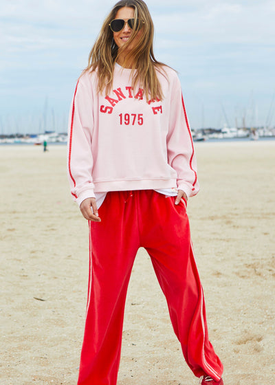 Hammill & Co Our standard fitting sweat with rib neck and waistband. Retro Santa Fe 1975 print on the front and double red velour tape down each sleeve.